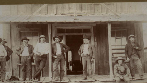 Old photo of people and
            saloon in Harney